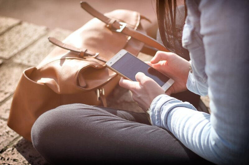 Person browsing a mobile optimized website on their cell phone