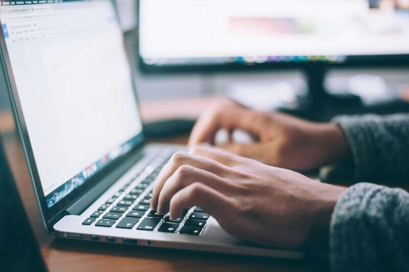 Person developing a website on a laptop